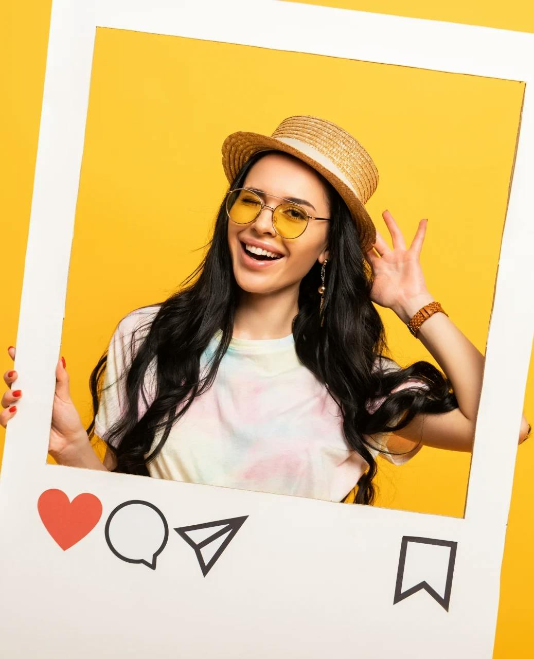 A happy, wealthy young woman ready to invest smiles through a cardboard Instagram post, ready to convert for a tearsheetads.com ad campaign.